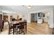 Open-concept living room with wood floors flowing into the kitchen featuring blue cabinets and stainless steel appliances at 7277 N College Ave, Indianapolis, IN 46240