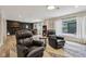 Inviting living room with hardwood floors, comfortable recliners, and backyard views at 7277 N College Ave, Indianapolis, IN 46240
