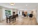 Open concept living room featuring wood floors, large windows, and comfortable seating area at 7277 N College Ave, Indianapolis, IN 46240