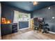 Bright home office with hardwood flooring, natural light, and modern desk at 7277 N College Ave, Indianapolis, IN 46240