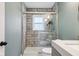 Bathroom featuring a shower with glass door, modern toilet and grey vanity at 7277 N College Ave, Indianapolis, IN 46240