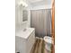 Clean bathroom featuring a modern vanity, laminate floors, and tiled shower at 734 W North St, Lebanon, IN 46052
