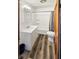 Bright bathroom features wood-look flooring, white vanity and framed mirror, with tub and shower at 734 W North St, Lebanon, IN 46052