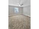 Bedroom featuring neutral carpet, gray walls, a ceiling fan and natural light from the window at 734 W North St, Lebanon, IN 46052