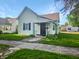 Charming home with a dark front door, manicured lawn and simple landscaping at 734 W North St, Lebanon, IN 46052