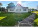Sunlit home showcasing lush lawn, complemented by a clear blue sky at 734 W North St, Lebanon, IN 46052