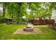 Fenced backyard with fire pit, deck, basketball hoop and storage shed at 7531 Mohawk Ln, Indianapolis, IN 46260
