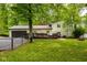 Fenced backyard features deck, garage and lush green lawn at 7531 Mohawk Ln, Indianapolis, IN 46260