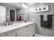 Modern bathroom features a double sink vanity with marble countertops and decorative artwork at 7531 Mohawk Ln, Indianapolis, IN 46260