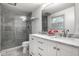 Elegant bathroom with a tiled shower, double sink vanity with marble countertop, and modern fixtures at 7531 Mohawk Ln, Indianapolis, IN 46260