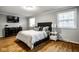 Cozy bedroom featuring hardwood floors, natural light, and a contemporary design at 7531 Mohawk Ln, Indianapolis, IN 46260