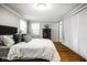 Bedroom with hardwood floors, closet, and natural light from the windows at 7531 Mohawk Ln, Indianapolis, IN 46260