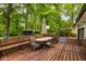 Outdoor deck features a dining table, an umbrella, and bench seating at 7531 Mohawk Ln, Indianapolis, IN 46260