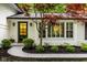 Close-up of the entrance and surrounding landscaping of a charming home at 7531 Mohawk Ln, Indianapolis, IN 46260
