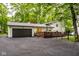 Exterior view of attached garage, deck, and backyard at 7531 Mohawk Ln, Indianapolis, IN 46260