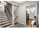 Hallway featuring decorative tile flooring and staircase access to the upper level at 7531 Mohawk Ln, Indianapolis, IN 46260