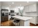 Spacious kitchen with stainless steel appliances, white cabinetry, and a large center island with seating at 7531 Mohawk Ln, Indianapolis, IN 46260