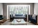 Comfortable living room with a modern aesthetic, featuring a large window and stylish decor at 7531 Mohawk Ln, Indianapolis, IN 46260