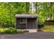 View of shed with bench, surrounded by mature trees and landscaping at 7531 Mohawk Ln, Indianapolis, IN 46260