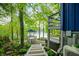 A tranquil backyard, complete with an umbrella-covered table set and glimpses of the lake at 7753 Ivy Dr, Nineveh, IN 46164