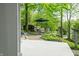 Inviting backyard patio with lush greenery, an umbrella, and the outdoor dining area at 7753 Ivy Dr, Nineveh, IN 46164