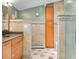 Bathroom features tiled floors, a wooden cabinet and a glass enclosed shower and tub at 7753 Ivy Dr, Nineveh, IN 46164