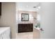 Modern bathroom features a dark vanity, square mirror, and tiled shower with a glass partition at 7753 Ivy Dr, Nineveh, IN 46164