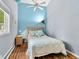 Cozy bedroom with light blue walls, wooden floors, ceiling fan and lots of natural light at 7753 Ivy Dr, Nineveh, IN 46164