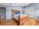 Well-lit bedroom featuring hardwood floors, a vaulted ceiling with a fan, and a wooden bed frame at 7753 Ivy Dr, Nineveh, IN 46164