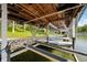 Covered boat dock with boat lifts and two kayaks, offering a convenient waterfront lifestyle at 7753 Ivy Dr, Nineveh, IN 46164
