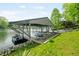 Picturesque boathouse on the water, perfect for boat storage and lakeside relaxation at 7753 Ivy Dr, Nineveh, IN 46164