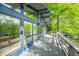 A long deck with blue trim runs along the back of this home and overlooks the trees at 7753 Ivy Dr, Nineveh, IN 46164