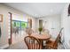 Bright dining area features a wooden table set with a view into the kitchen and bar seating at 7753 Ivy Dr, Nineveh, IN 46164