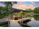 Waterfront covered boat dock with platform featuring sunset views, perfect for lake living at 7753 Ivy Dr, Nineveh, IN 46164