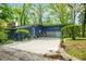 Charming blue home with a spacious driveway, lush landscaping, and a welcoming entrance at 7753 Ivy Dr, Nineveh, IN 46164