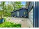 Stylish home exterior with blue siding, front patio seating, and a beautifully maintained driveway at 7753 Ivy Dr, Nineveh, IN 46164