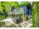 Charming exterior view of a modern home featuring a patio, hot tub, and surrounding greenery at 7753 Ivy Dr, Nineveh, IN 46164