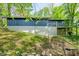 The back exterior view shows a home built into a hill with a daylight basement at 7753 Ivy Dr, Nineveh, IN 46164