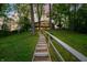 Scenic exterior view of a lake house surrounded by trees, featuring stairway access at 7753 Ivy Dr, Nineveh, IN 46164