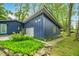 Charming blue home with modern design, featuring a gray garage door and lush green landscaping at 7753 Ivy Dr, Nineveh, IN 46164