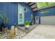 Inviting front entrance with light blue door, vibrant blue siding and a cozy seating area at 7753 Ivy Dr, Nineveh, IN 46164