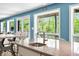 Granite kitchen island with sink and seating, plus bright views and access to deck at 7753 Ivy Dr, Nineveh, IN 46164