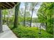 Tranquil lake view from the lower patio, complemented by lush greenery and a peaceful ambiance at 7753 Ivy Dr, Nineveh, IN 46164