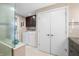 Bright laundry area with washer, dryer, dark wood cabinetry, and doors to the bathroom at 7753 Ivy Dr, Nineveh, IN 46164