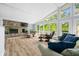 Bright living room boasts a stone fireplace, floor-to-ceiling windows, and hardwood floors at 7753 Ivy Dr, Nineveh, IN 46164