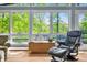 The living room has walls of windows overlooking trees at 7753 Ivy Dr, Nineveh, IN 46164
