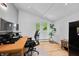 Bright home office with a wooden desk, large monitor and lovely backyard view at 7753 Ivy Dr, Nineveh, IN 46164