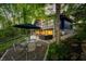 Outdoor patio with a table and chairs next to a hot tub, surrounded by lush greenery at 7753 Ivy Dr, Nineveh, IN 46164
