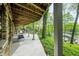 Spacious outdoor patio and comfortable seating with lush greenery and stunning lake views beyond at 7753 Ivy Dr, Nineveh, IN 46164