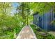 Brick pathway amidst lush greenery, leading to a lakefront home with serene surroundings at 7753 Ivy Dr, Nineveh, IN 46164